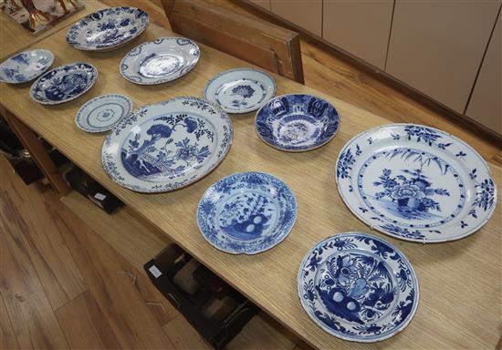 A collection of eleven 18th century Delft blue and white dishes largest diameter 35cm (mostly a.f.)